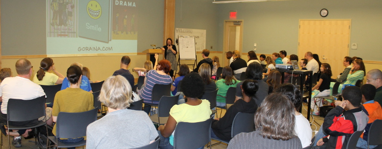 Raina Telgemeier presents her work to fans of all ages before a book signing, 2013.
